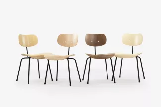 The SE 68 Multi Purpose Chair with a black frame and all natural wood variations in an ensemble studio setting.