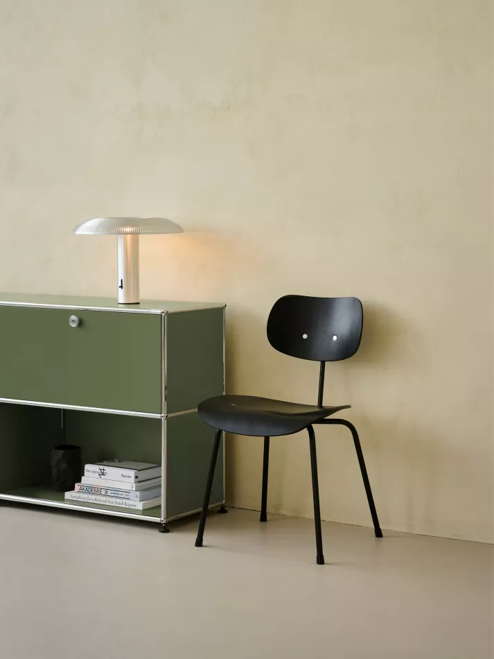 The SE 68 multi purpose chair next to a USM shelf